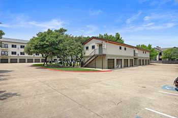 an empty parking lot in front of a building at Artisan Apartments & Shops, Austin